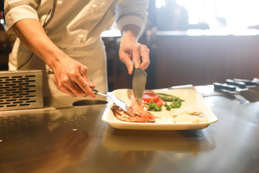 Chef plating a dish during a culinary lesson
